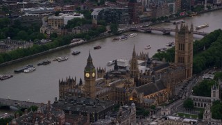 AX116_060 - 5.5K stock footage aerial video of Big Ben and British Parliament on River Thames, London, England, twilight
