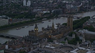 AX116_061E - 5.5K aerial stock footage of Big Ben and British Parliament beside River Thames, London, England, twilight