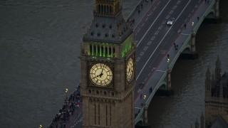 AX116_064 - 5.5K aerial stock footage of an orbit of Big Ben by the River Thames, London, England, twilight