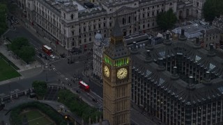 AX116_076E - 5.5K aerial stock footage of flying by famous Big Ben in London, England, twilight