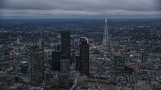 AX116_091E - 5.5K aerial stock footage flyby skyscrapers and cityscape, The Shard in background, London, England, twilight