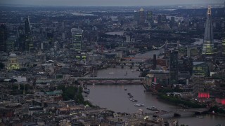 AX116_108 - 5.5K aerial stock footage a view of bridges, River Thames, tall skyscrapers and cityscape, London, England, night
