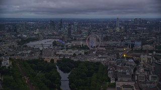 AX116_115 - 5.5K aerial stock footage skyscrapers seen from near London Eye and Big Ben by River Thames, London, England, night