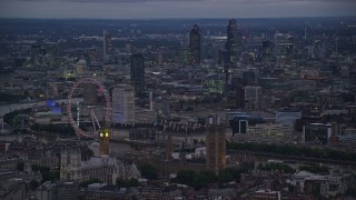AX116_119 - 5.5K stock footage aerial video passing London Eye, Big Ben and British Parliament, London, England, night
