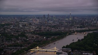AX116_131 - 5.5K aerial stock footage wide view of London from River Thames and Albert Bridge, England, night