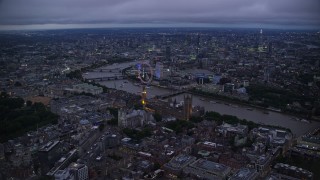 AX116_139E - 5.5K aerial stock footage approach Big Ben, British Parliament, London Eye, and River Thames, London, England, night