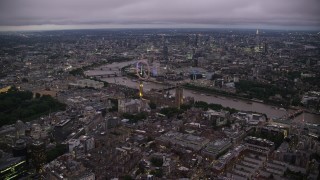 AX116_140 - 5.5K stock footage aerial video approach Big Ben, British Parliament, London Eye, and Westminster Abbey, London, England, night