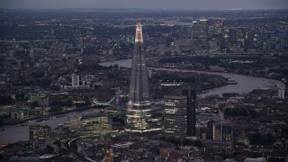 AX116_145 - 5.5K aerial stock footage of a view of The Shard skyscraper and River Thames, London, England, night