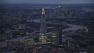 AX116_145E - 5.5K aerial stock footage of a view of The Shard skyscraper and River Thames, London, England, night