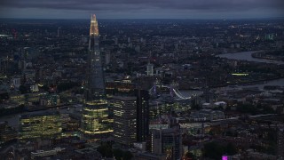 AX116_150 - 5.5K aerial stock footage of The Shard skyscraper near the Tower Bridge, London, England, night
