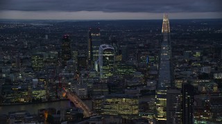 AX116_152E - 5.5K aerial stock footage of flying by The Shard and Central London skyscrapers, London, England, night