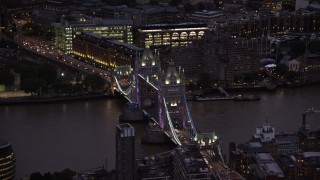 AX116_155 - 5.5K stock footage aerial video of orbiting Tower Bridge spanning River Thames, London, England, night