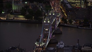AX116_156 - 5.5K stock footage aerial video of an orbit of Tower Bridge spanning River Thames, London, England, night