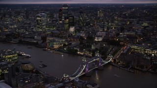 AX116_157 - 5.5K stock footage aerial video orbiting Tower Bridge and River Thames near Tower of London, England, night