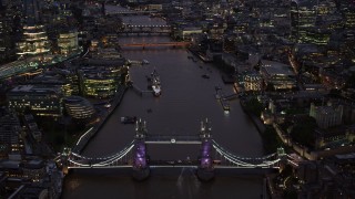 AX116_159 - 5.5K stock footage aerial video of orbiting Tower Bridge and River Thames in London, England, night