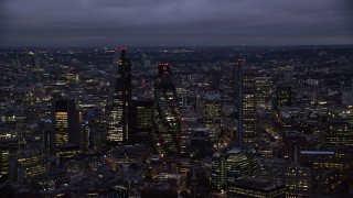 AX116_161 - 5.5K stock footage aerial video flyby Leadenhall Building, The Gherkin, Heron Tower in London, England, night
