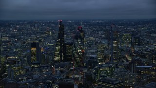 AX116_161E - 5.5K aerial stock footage flyby Leadenhall Building, The Gherkin, Heron Tower in London, England, night