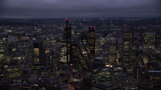 AX116_162 - 5.5K aerial stock footage of Leadenhall Building, Gherkin, Tower 42, Heron Tower skyscrapers, London, England, night