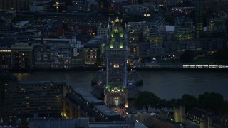 AX116_164E - 5.5K aerial stock footage of passing the famous Tower Bridge over River Thames, London, England, night