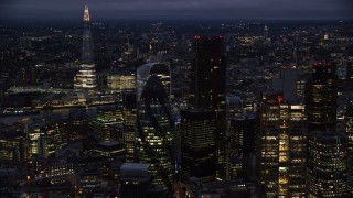AX116_167 - 5.5K aerial stock footage of The Gherkin seen from Heron Tower, The Shard in background, London, England, night