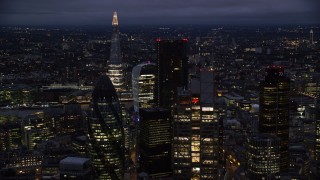 AX116_168 - 5.5K stock footage aerial video of flying by Central London skyscrapers, The Shard in background, England, night