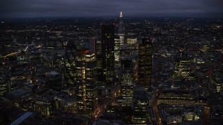 AX116_169 - 5.5K stock footage aerial video orbiting Central London skyscrapers with The Shard in background, England, night
