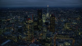 AX116_169E - 5.5K aerial stock footage of Central London skyscrapers with The Shard in background, England, night