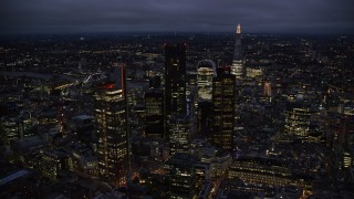 AX116_170 - 5.5K stock footage aerial video of passing by Central London skyscrapers, The Shard in background, England, night