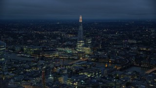 AX116_173 - 5.5K aerial stock footage of a view of The Shard and River Thames, London, England, night