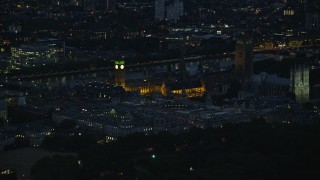 AX116_189 - 5.5K aerial stock footage of flying by Big Ben, British Parliament and Westminster Abbey, London, England, night