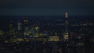 AX116_200 - 5.5K aerial stock footage of a view of The Shard and skyscrapers in Central London, England, night
