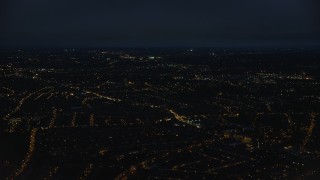 AX116_202 - 5.5K aerial stock footage of flying by residential neighborhoods in London, England, night