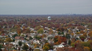 AX117_001E - 5.5K aerial stock footage of suburban residential neighborhood in Autumn, Farmingdale, New York