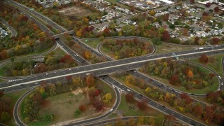 AX117_012E - 5.5K aerial stock footage of a freeway interchange in Autumn, Massapequa, New York