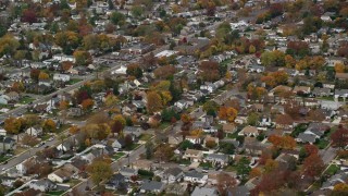 AX117_017E - 5.5K aerial stock footage approaching a suburban homes in Autumn, North Bellmore, New York
