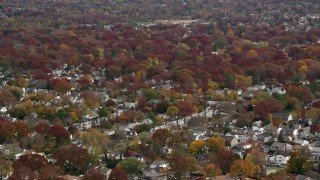 AX117_022E - 5.5K aerial stock footage of circling a suburban neighborhood in Autumn, Merrick, New York