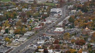AX117_041 - 5.5K aerial stock footage of homes and shops on a Main Street in Autumn, Bellmore, New York