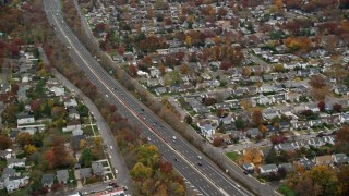 AX117_050E - 5.5K aerial stock footage of light traffic on freeway in Autumn, Seaford, New York