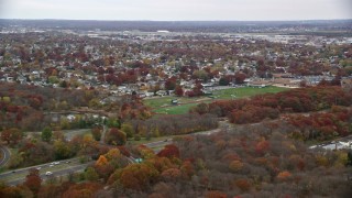 AX117_055E - 5.5K aerial stock footage fly over suburbs and nature preserve toward high school in Autumn, Massapequa, New York