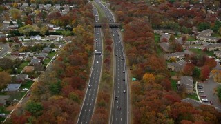 AX117_058E - 5.5K aerial stock footage of a freeway with light traffic in Autumn, Farmingdale, New York