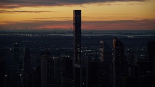 AX118_001E - 5.5K aerial stock footage of 432 Park Avenue condo high-rise at sunrise in Midtown Manhattan, New York City