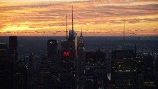 AX118_006 - 5.5K aerial stock footage of Chrysler Building and skyscrapers in Midtown at sunrise, New York City