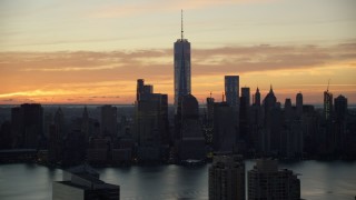 AX118_030E - 5.5K aerial stock footage of a view of the World Trade Center skyline at sunrise in Lower Manhattan, New York City