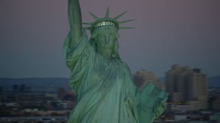 AX118_058 - 5.5K aerial stock footage of orbiting the famous Statue of Liberty at sunrise, New York