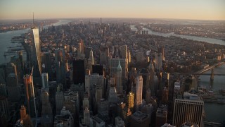 AX118_087E - 5.5K stock footage aerial video of Lower and Midtown Manhattan skyscrapers at sunrise, New York City
