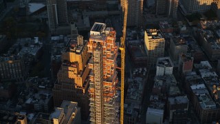 AX118_092E - 5.5K aerial stock footage of 56 Leonard Street condo complex at sunrise in Tribeca, New York City