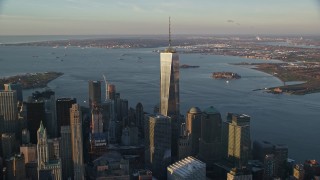 AX118_094E - 5.5K aerial stock footage of gleaming Freedom Tower at sunrise in Lower Manhattan, New York City