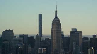 AX118_166 - 5.5K aerial stock footage of the iconic Empire State Building at sunrise in Midtown, New York City