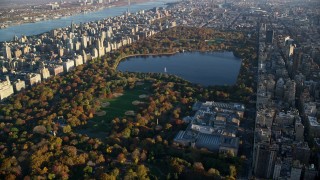 AX118_192 - 5.5K stock footage aerial video of Central Park and The Met with Autumn leaves at sunrise in New York City