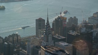 AX118_201E - 5.5K aerial stock footage of orbiting the Chrysler Building at sunrise in New York City